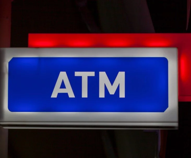 Clearly marked bank ATM with branded signage visible from the parking area