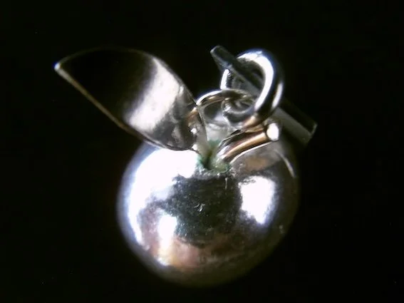 Apple,   On Landguard Point     (2012), silver charm by Victoria Constable