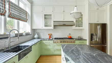 Soapstone countertops and island in colourful kitchen