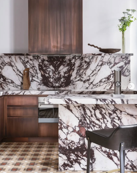 Bold marble on modern kitchen countertops, backsplash, and island.