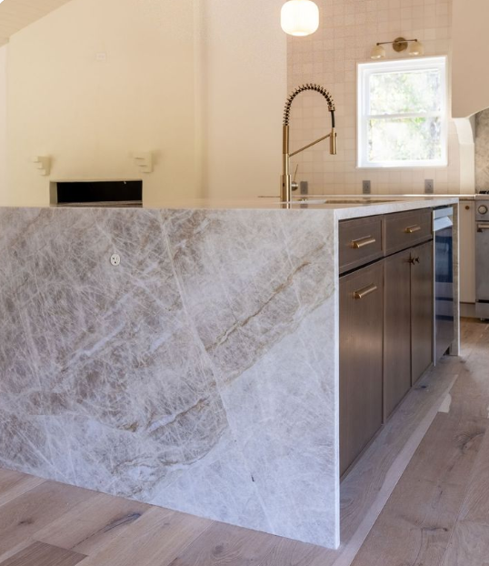 Quartzite countertop and waterfall edge on kitchen countertop