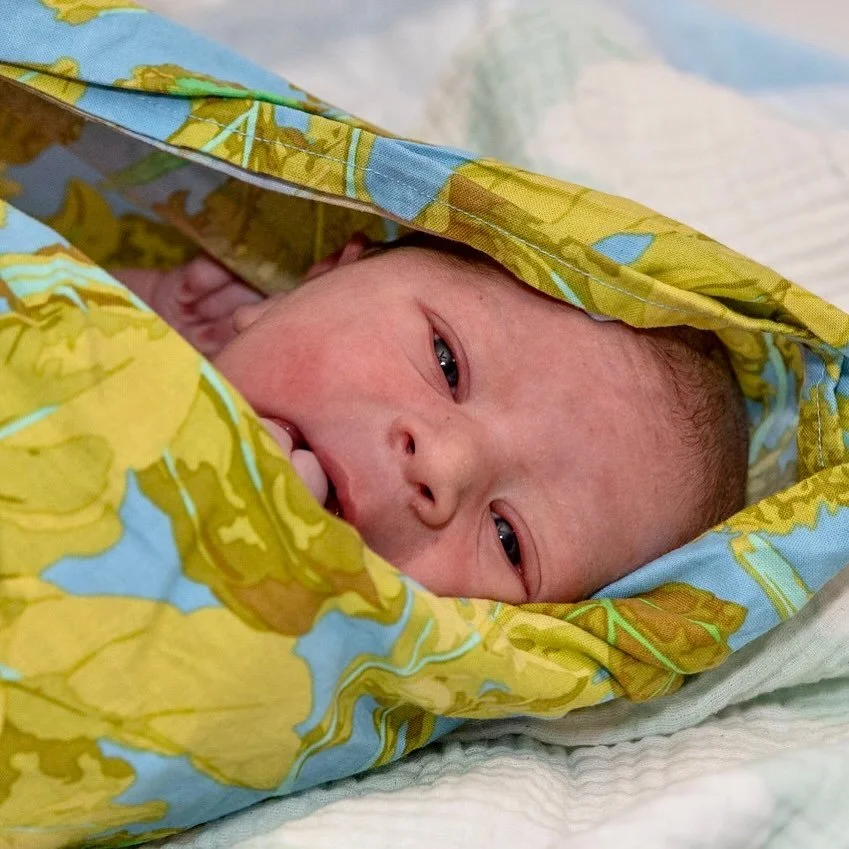 Peek-a-boo. The midwives I&rsquo;ve worked with always use one of these cloth wraps and a scale to weigh the baby. It hangs from a small metal scale with baby inside&hellip;. Usually a little foot is peeking out! &mdash; Hey MIDWIVES out there, chime