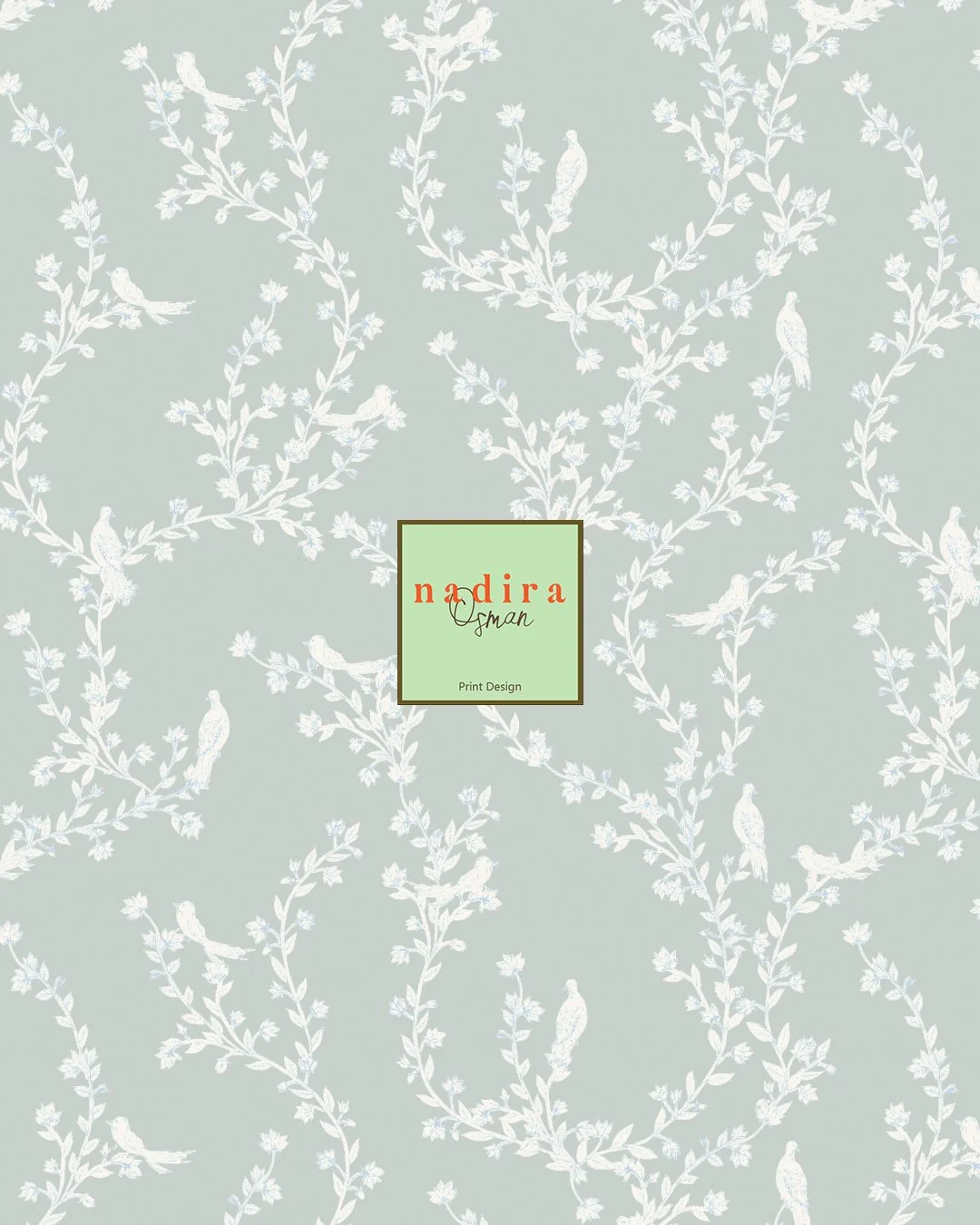 Soft, graceful, and full of charm. This wallpaper features delicate birds perched among winding floral vines, creating a pattern that feels both classic and fresh. The dusty blue background paired with crisp white detailing gives it a light, airy fee
