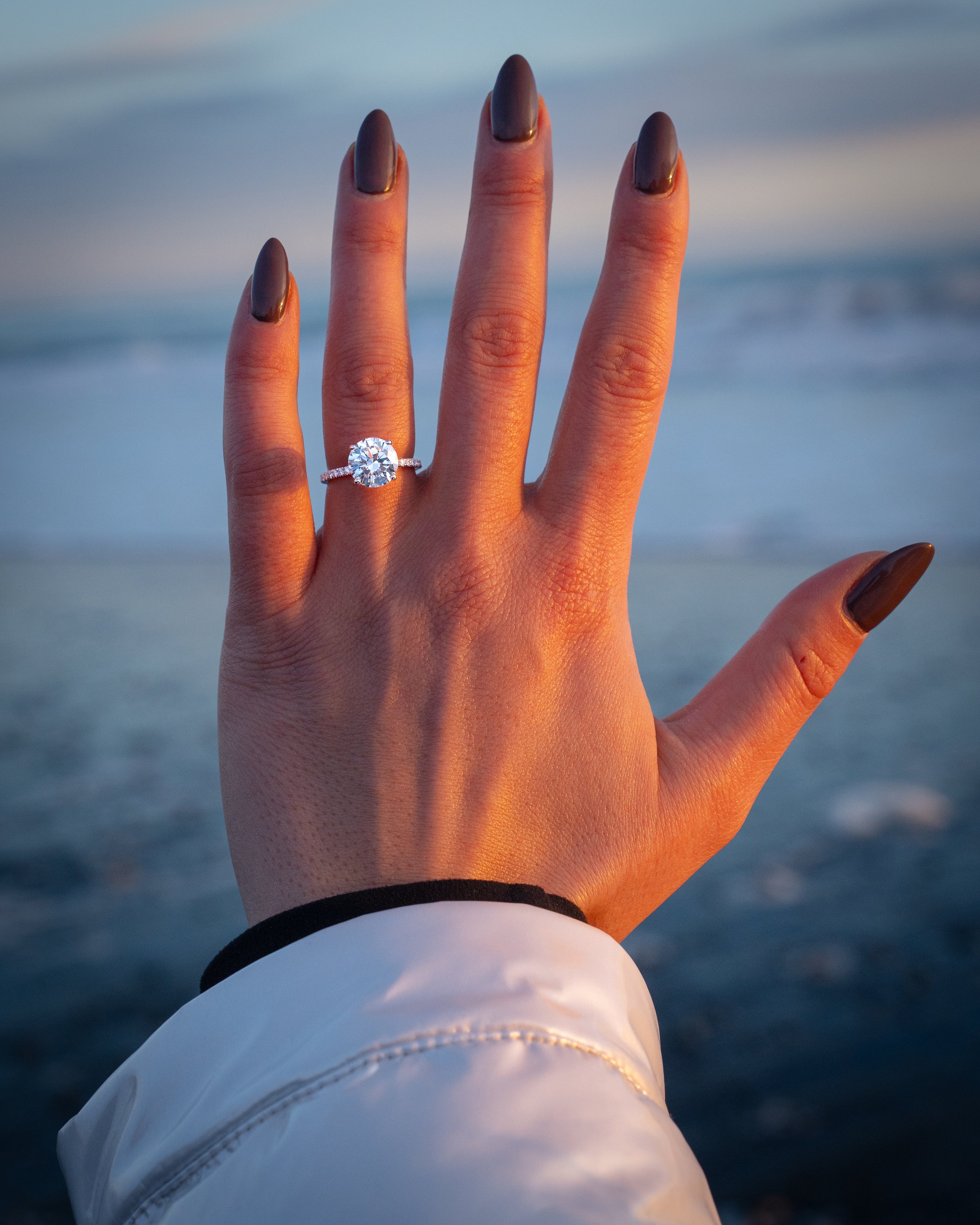 Young adult woman holding her hand with engaging ring in Iceland , during romantic Engagement,  Marriage Engagement, Engagement Iceland, Engagement Photographer, Surprise Engagement, Secret Engagement, Proposal , Proposal Iceland, Proposal Photograph