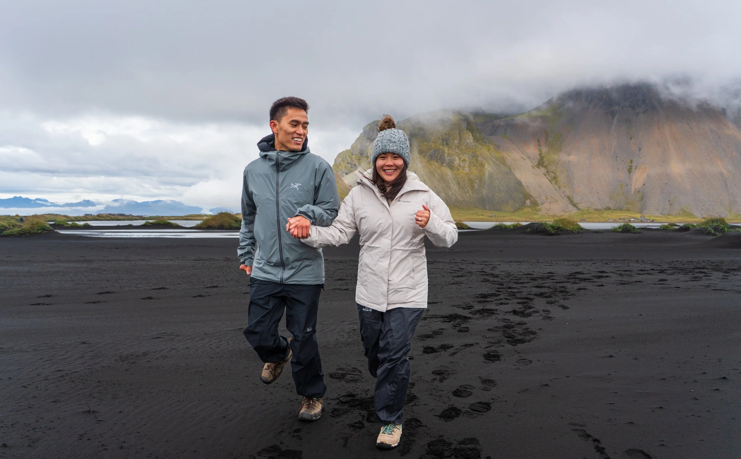 young running couple and in front of Vestrahorn in Iceland during romantic Engagement,  Marriage Engagement, Engagement Iceland, Engagement Photographer, Surprise Engagement, Secret Engagement, Proposal, Proposal Iceland, Proposal Photographer, Surpr