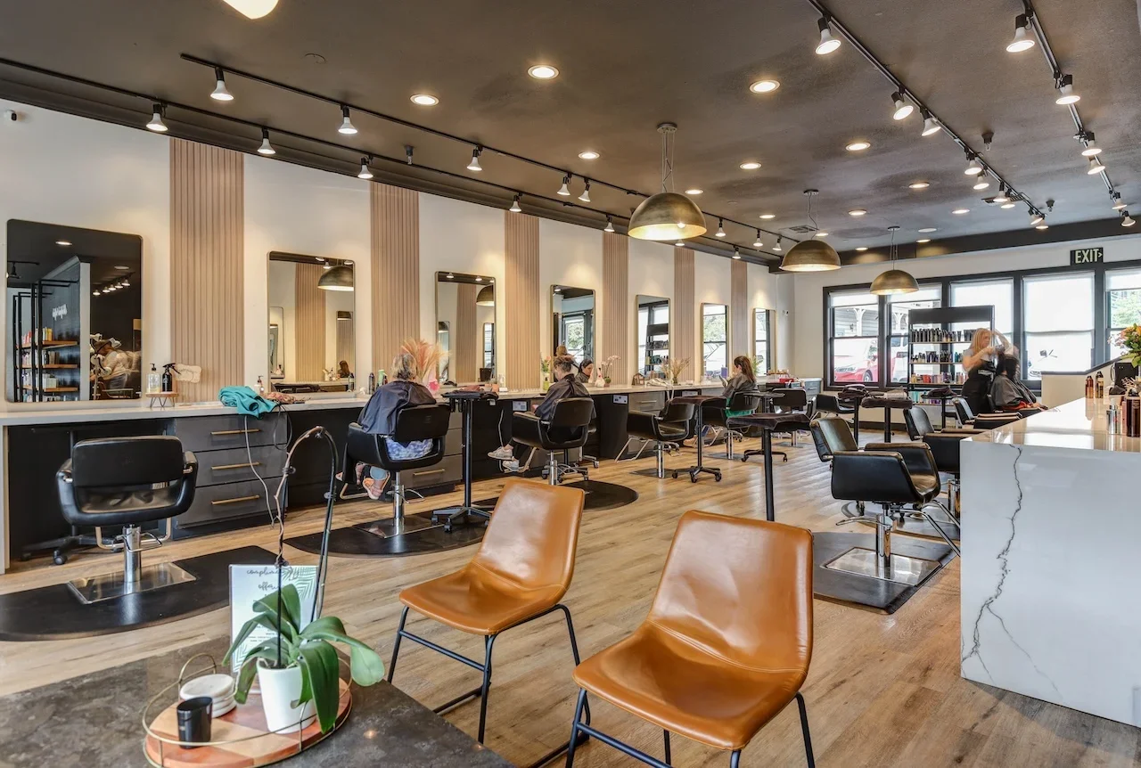 Modern interior of Theory Salon in Pleasanton, CA featuring multiple styling stations, expert stylists, and luxury design — the best hair salon for color, balayage, and extensions in the Tri-Valley area.