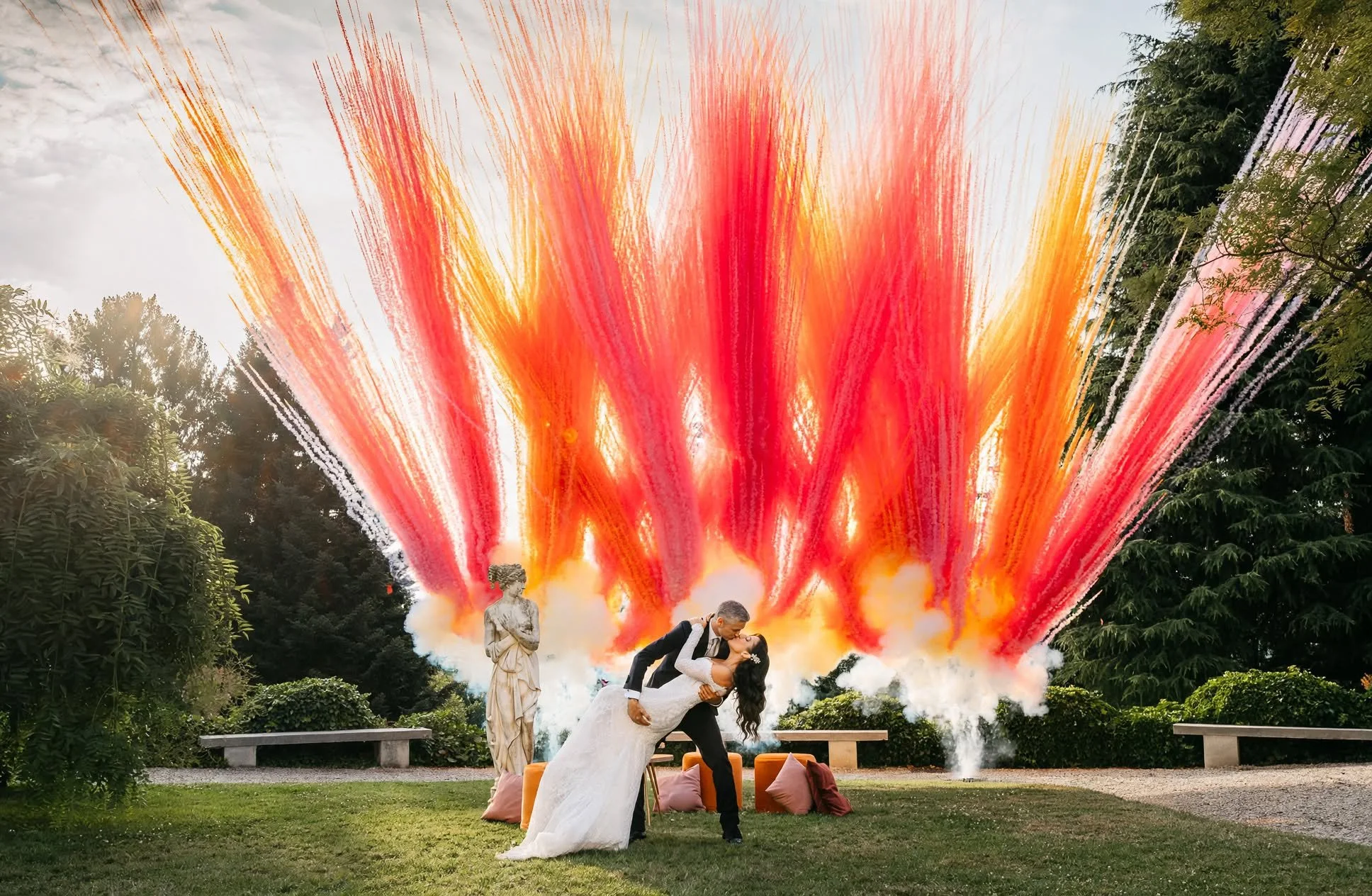 newlyweds with colour bomb in the background