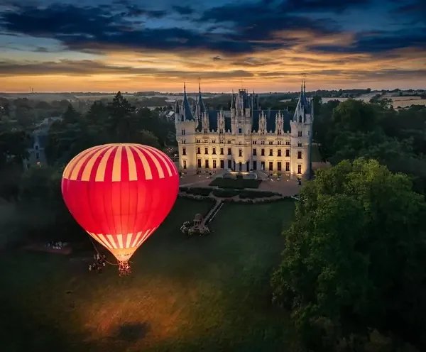 Hot air balloon at sunset over Chateau Challain - destination wedding France