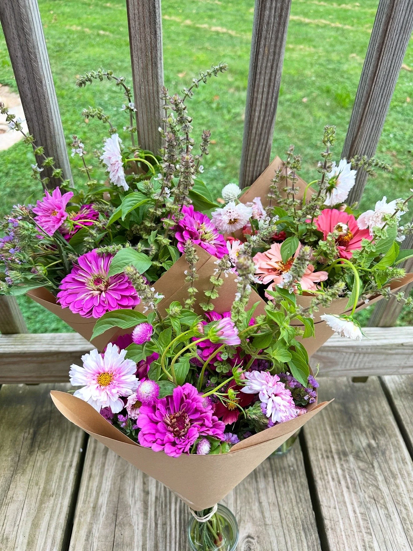 wrapped kraft brown paper bouquets on the porch in mason jars