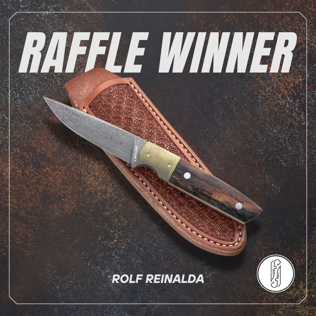 A folding pocket knife with a patterned metal blade and wood handle, placed on a leather sheath. The background is textured and dark.