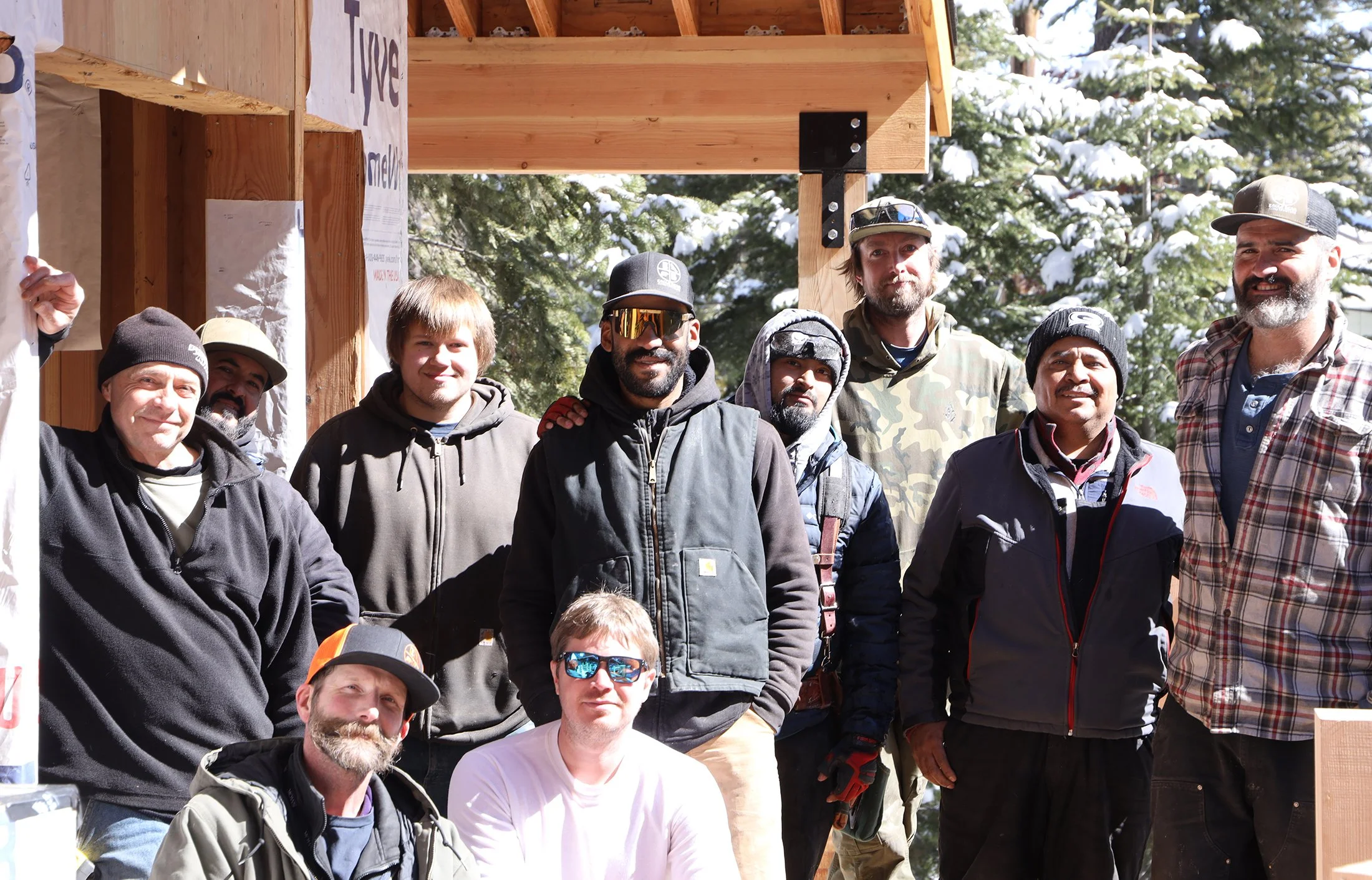 the crew at eagle bear construction with steven kirk at a new construction site standing on new deck in winter