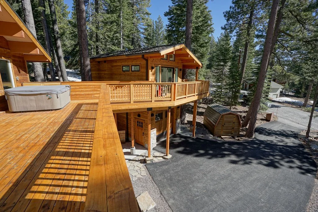 hot tub and view of garage and adu from deck of main house