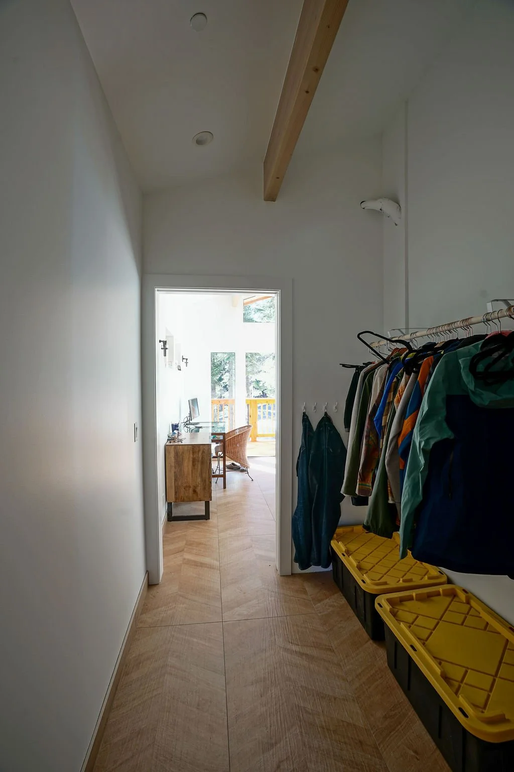 looking down entryway with storage to main room