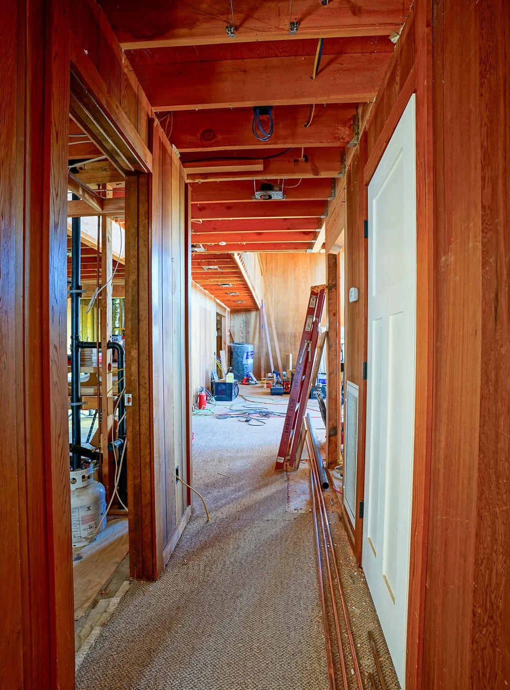 interior hallway with wood beams and white door