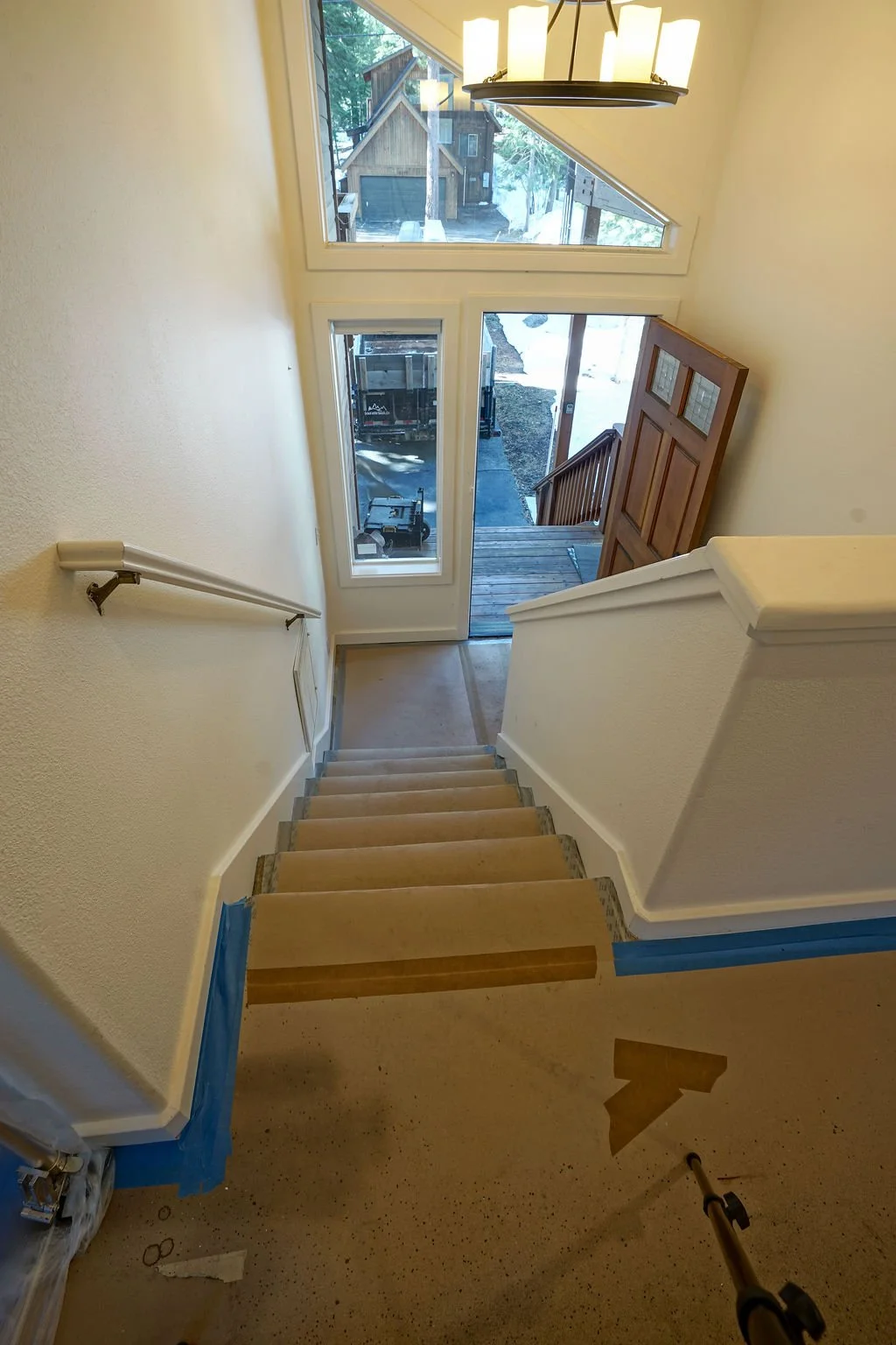 looking down stairway to front door