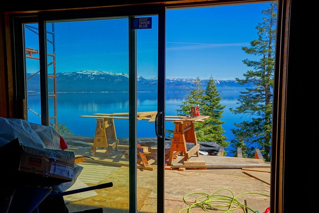 view out sliding glass door of new construction deck and Lake Tahoe