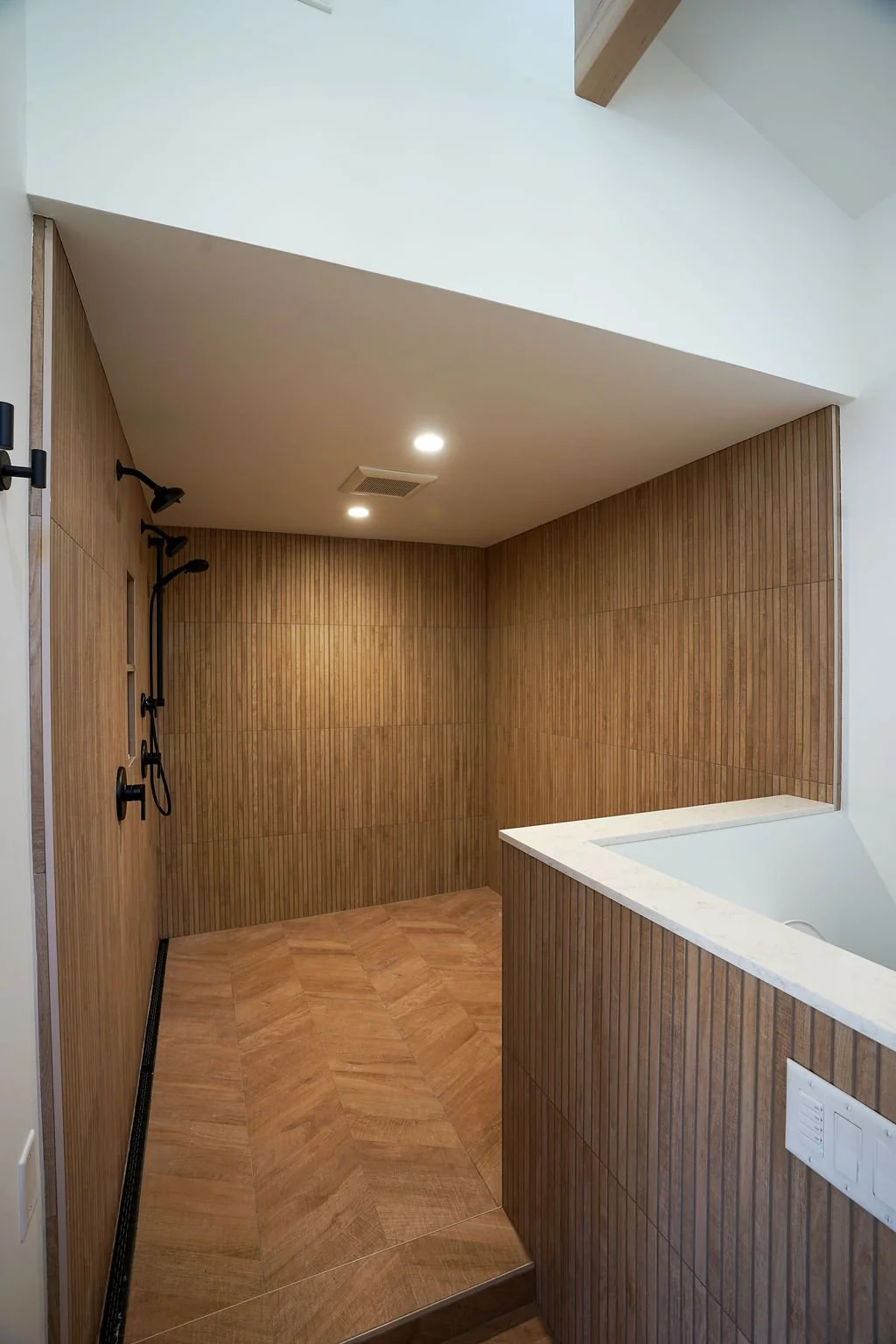 large shower with open entry and high ceiling