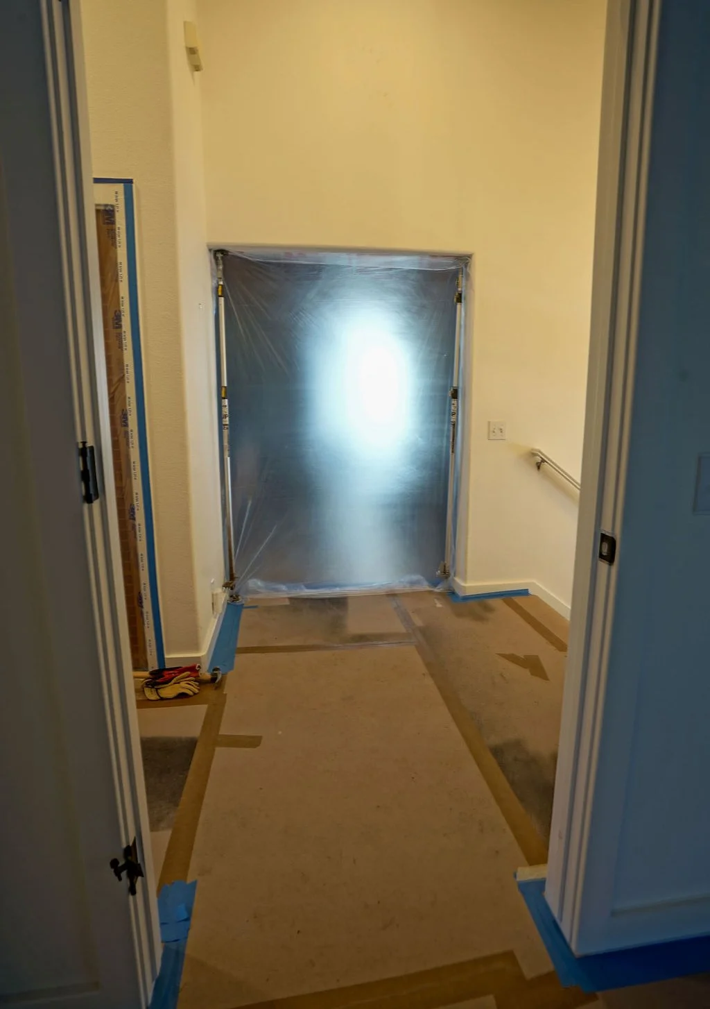 main hallway with plastic covering door