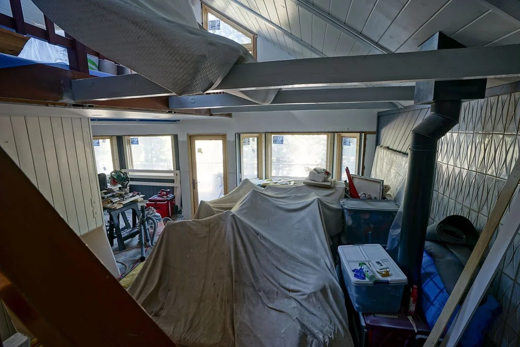 covered furniture filling room with new windows