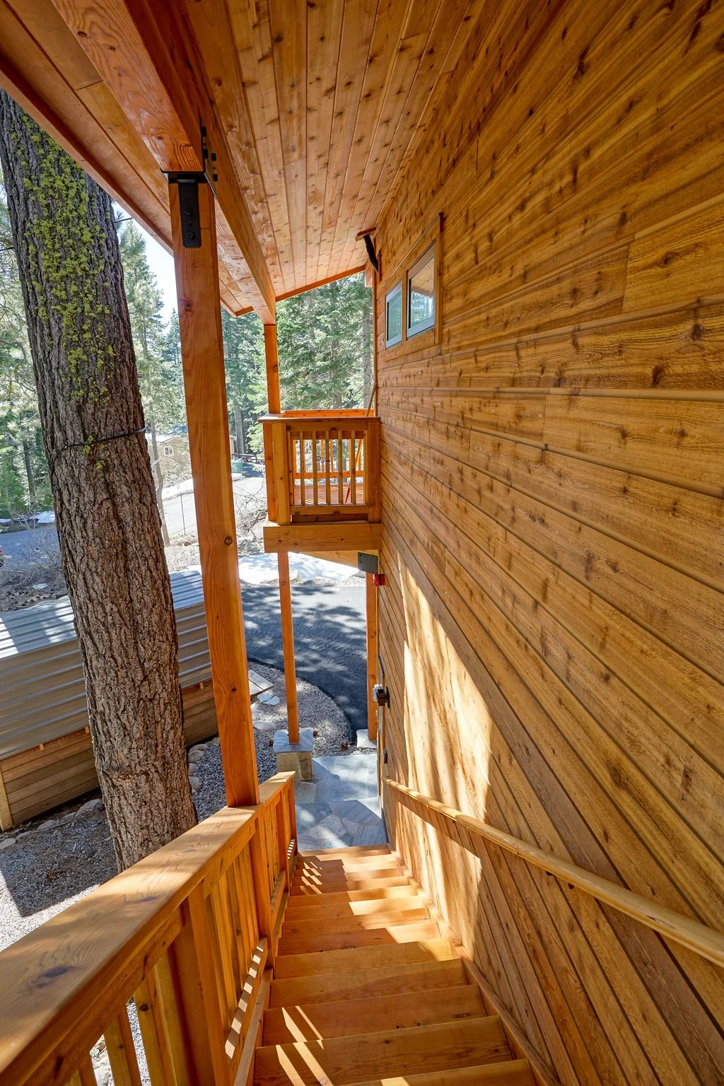 looking down wooden stairs to driveway
