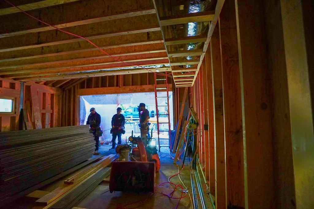 framed garage with workers
