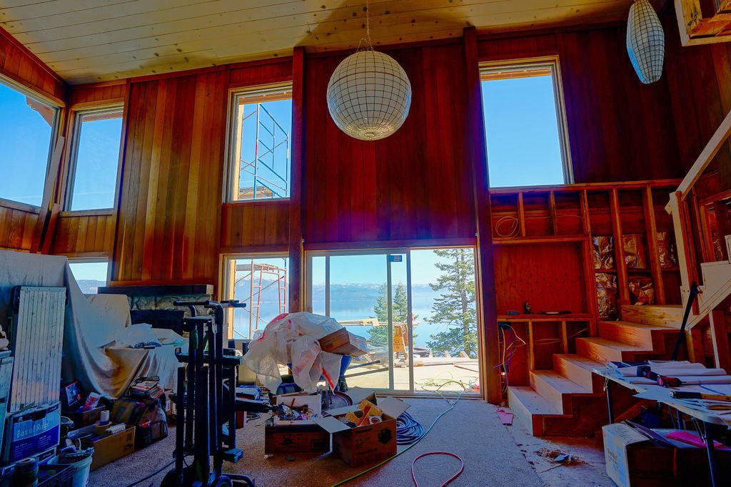 large room with covered items in disarray