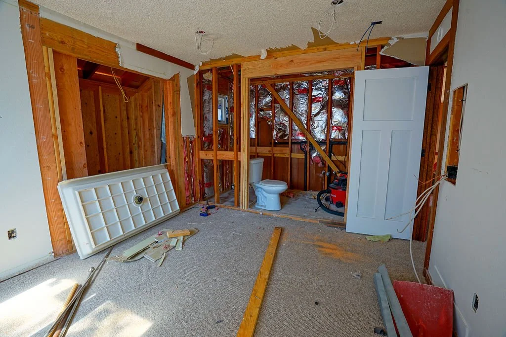 bedroom under construction with open wall to bathroom