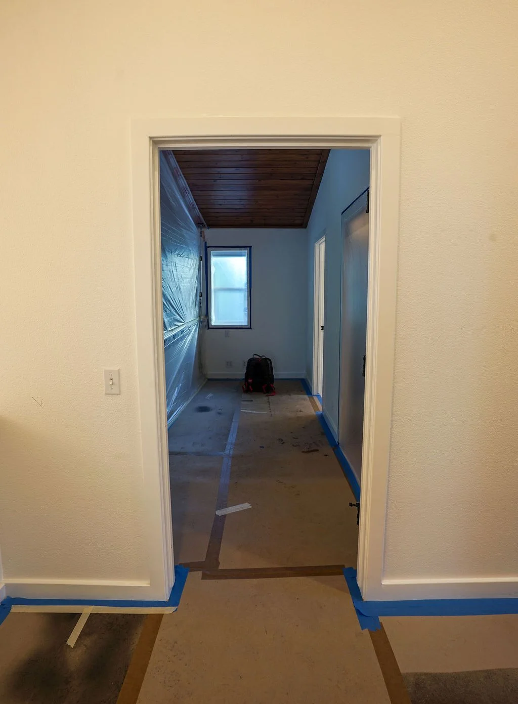 looking through doorway into room with plastic