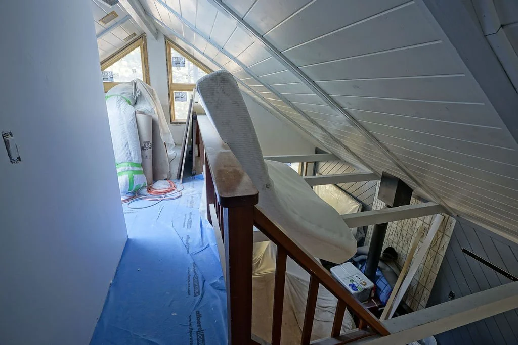 looking down a hallway with blue floor covering