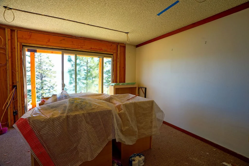 items covered in plastic in room with white paint