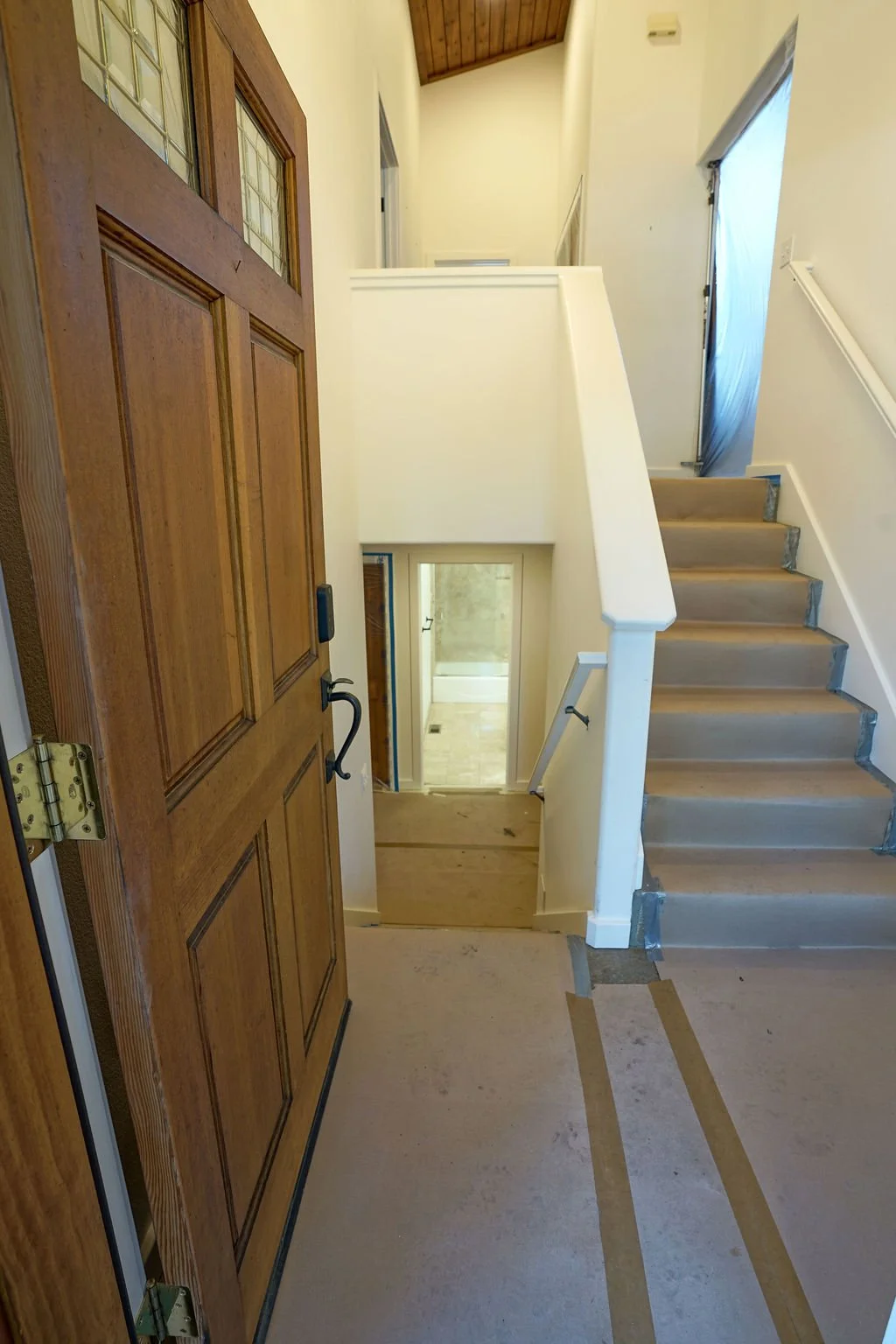 looking in front door to hallway and up stairway