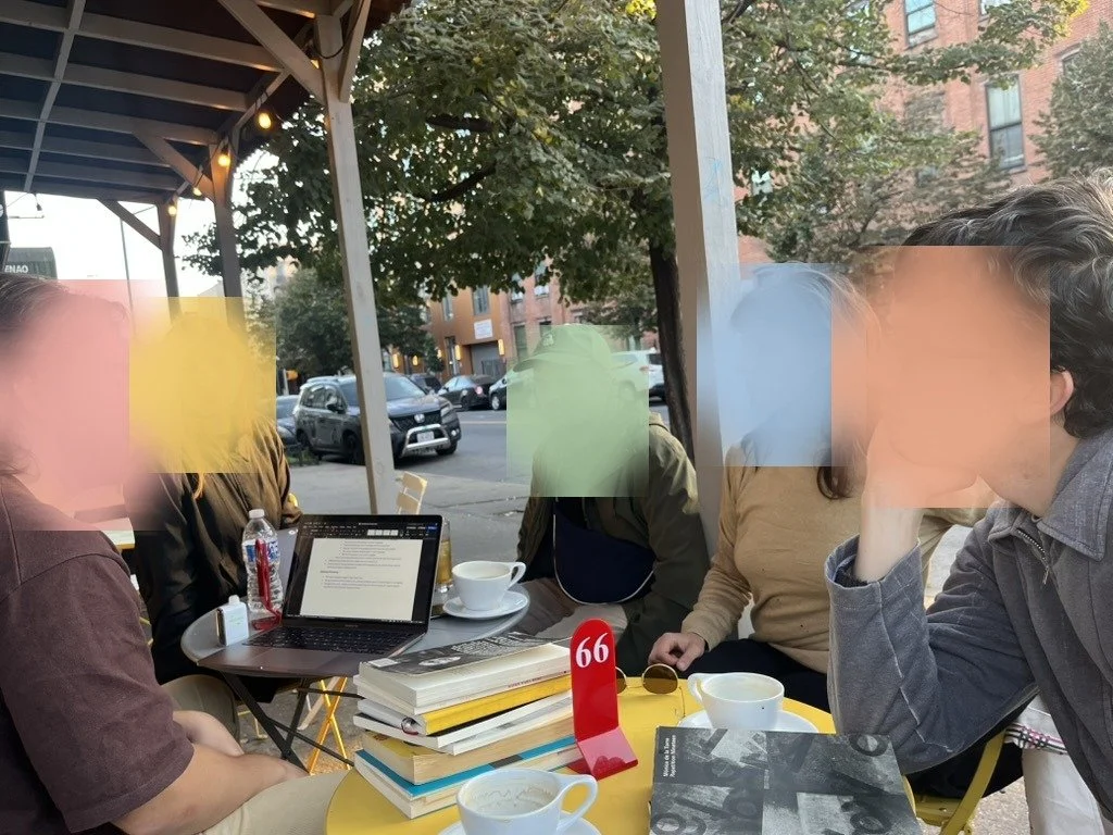 Working session at a cafe table with books and a laptop