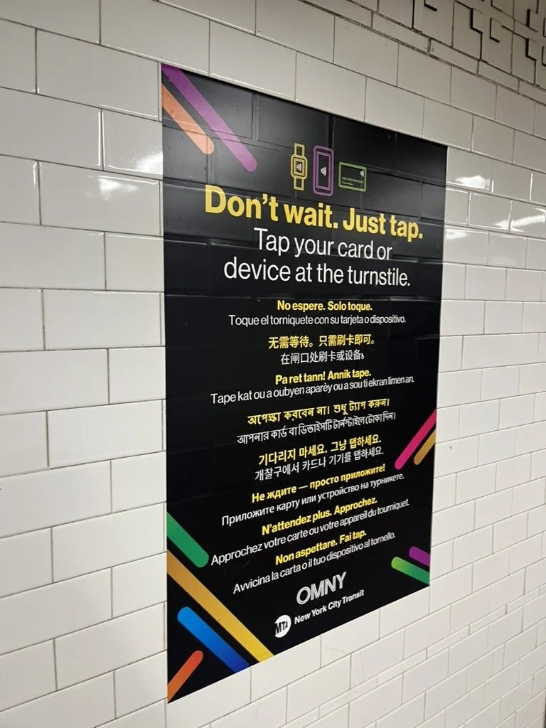 Multilingual sign in a New York subway station: Don't wait. Just tap.