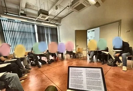 Reading circle at Sapienza University, Rome, with the text on a laptop screen