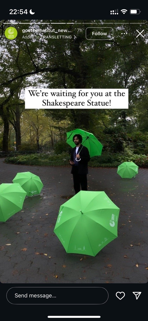 Green umbrellas at the Shakespeare Statue, Central Park, with the message "We're waiting for you at the Shakespeare Statue!"