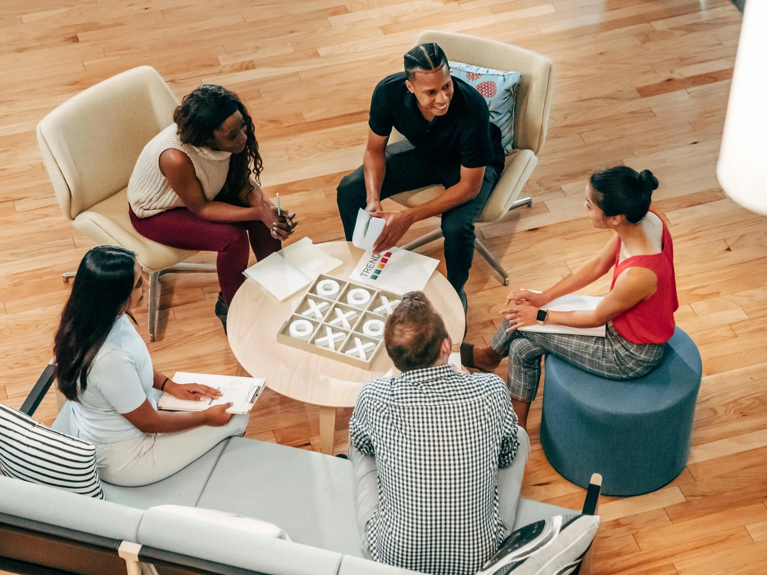 Group meeting around a table with notes and papers