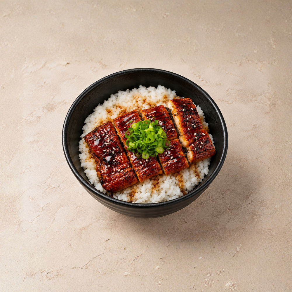 Charcoal-grilled unagi glazed in tare sauce, served over rice with pickles and spring onions. A smoky, flavorful option perfect for lunch or dinner.