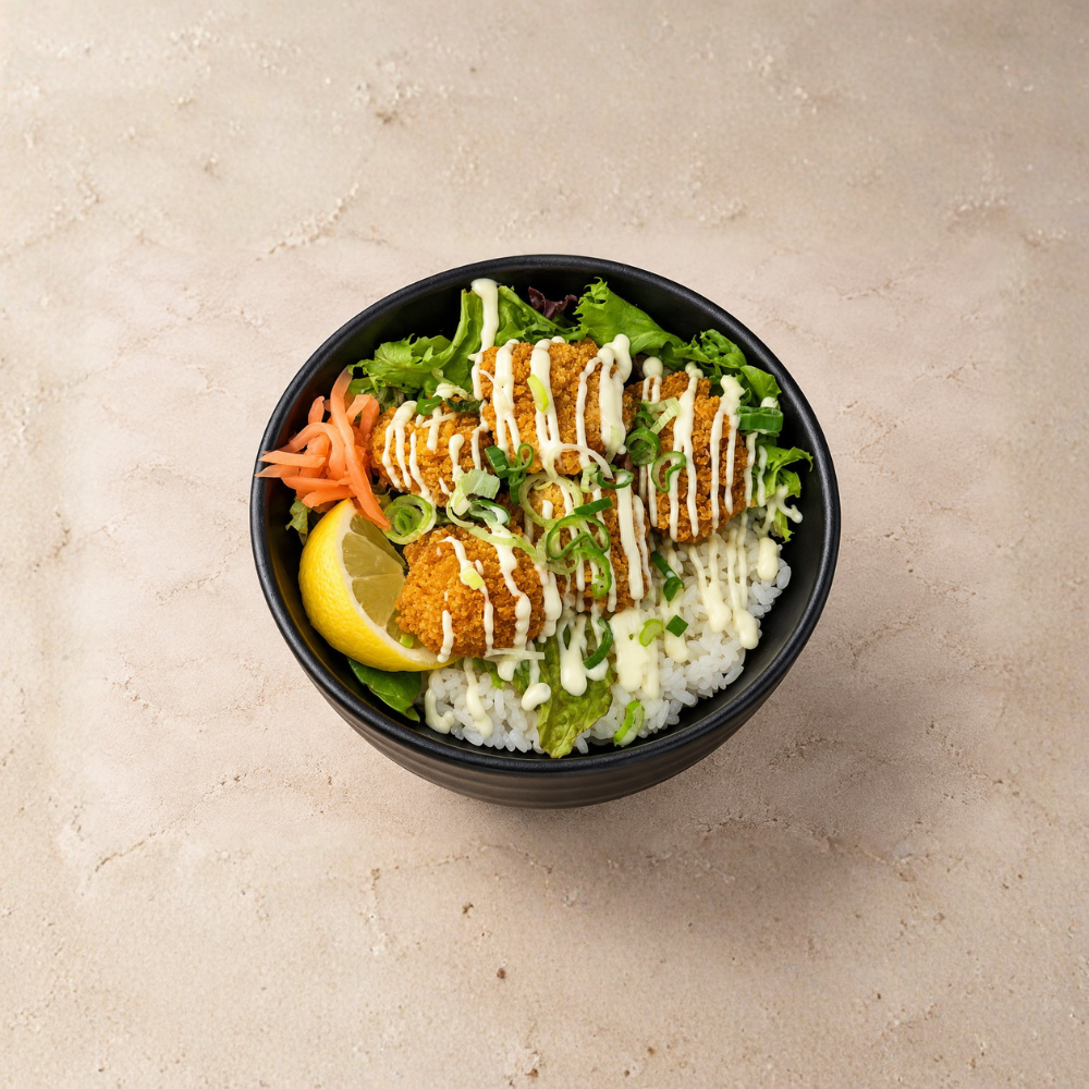 SHŌRI’s Chicken Karaage Don – crispy, golden Japanese fried chicken served atop a bed of perfectly steamed rice, drizzled with house-made sauce, and garnished with fresh spring onions and pickles for a bold, satisfying bite.