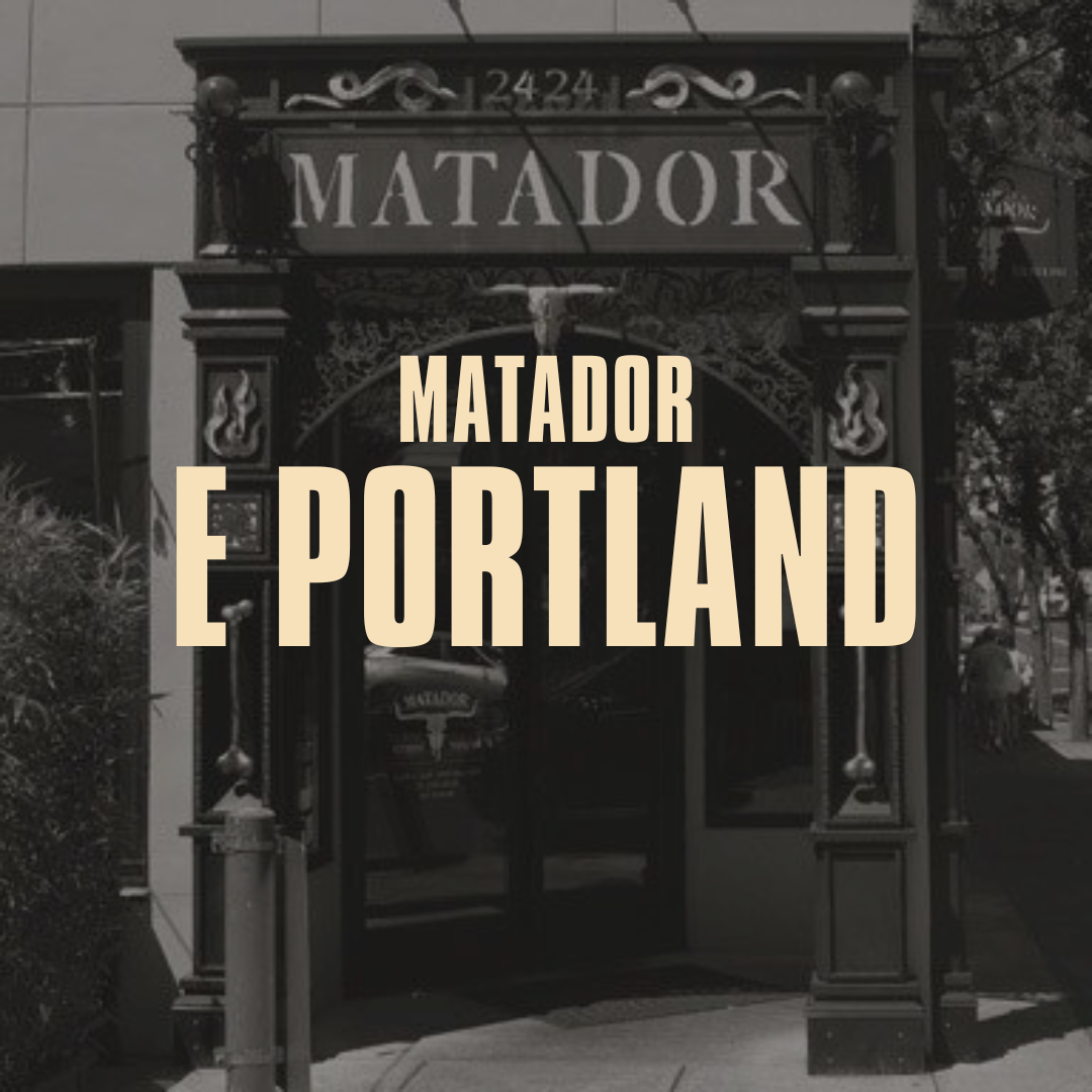 Black and white photo of the entrance to a restaurant or bar called Matador, with decorative elements around the doorway and the address 2424 above.