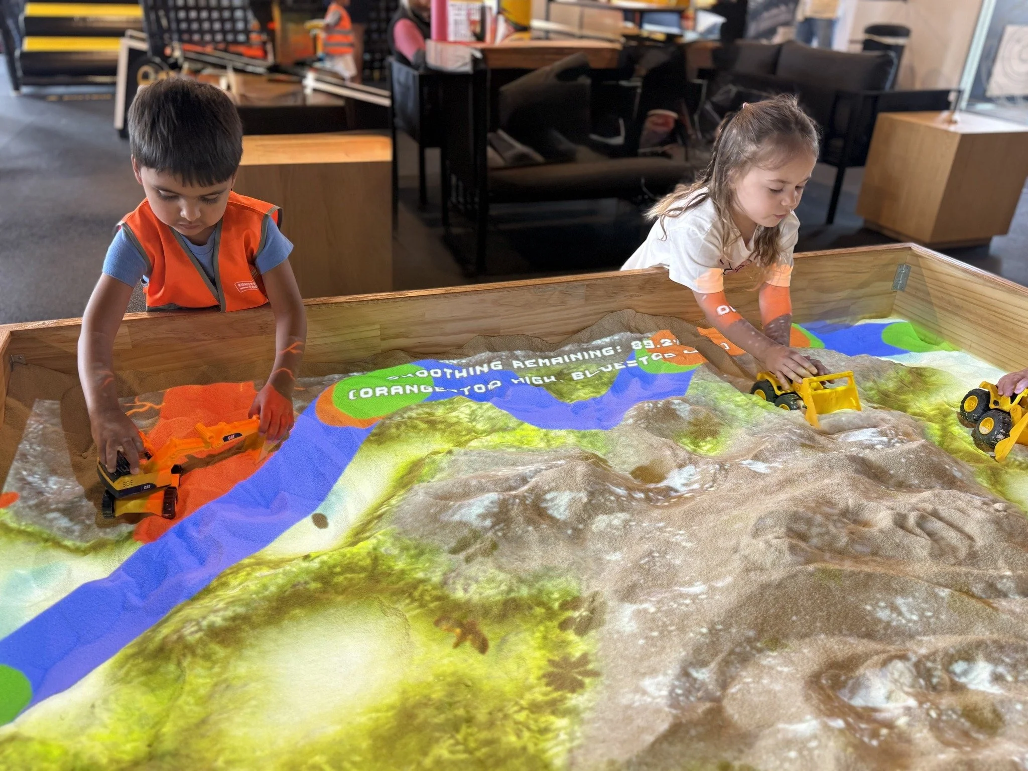 child playing in sand table at Construction Corner indoor play space Powell Ohio