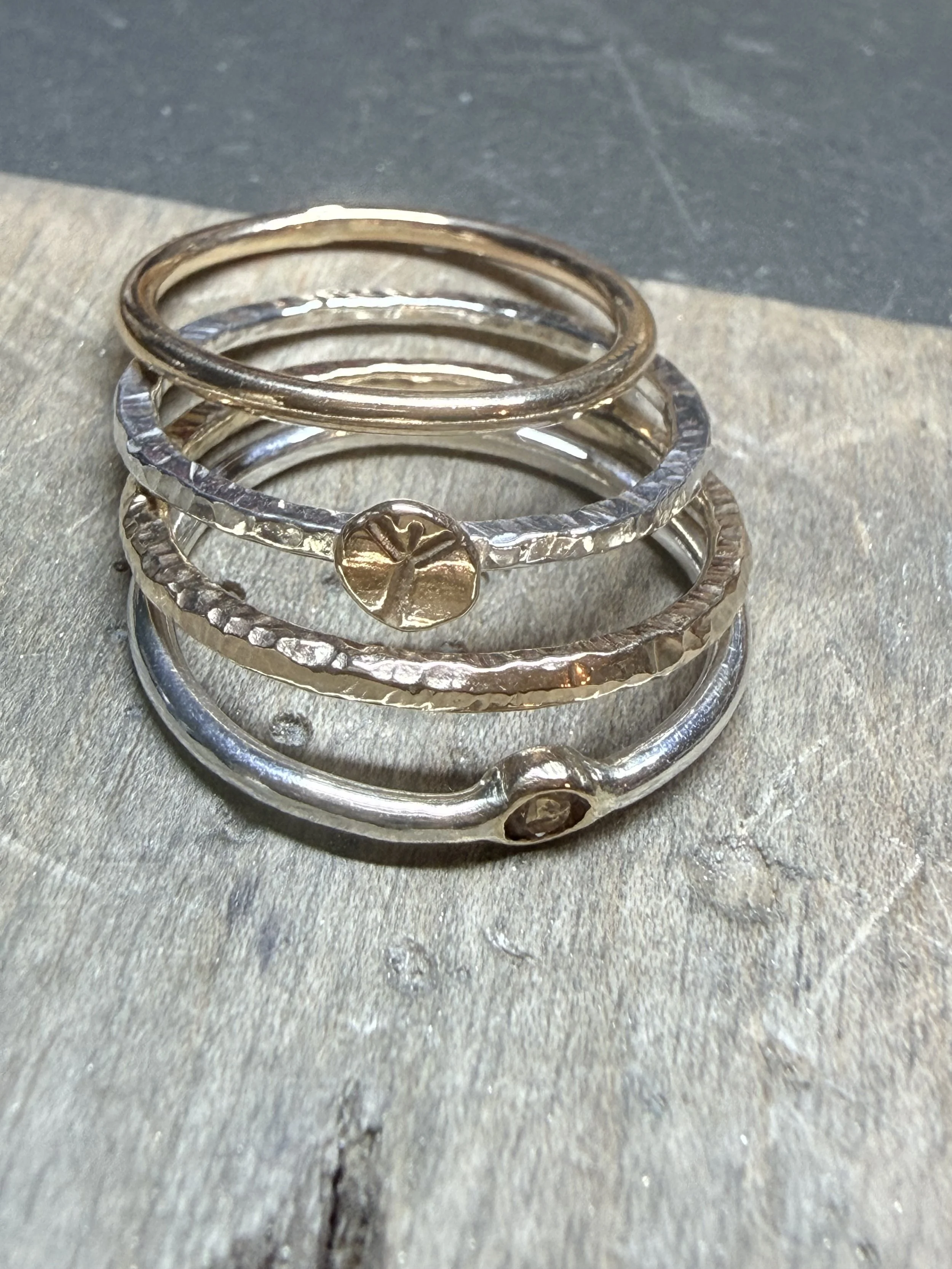 9K gold, sterling silver and peridot stacking rings.