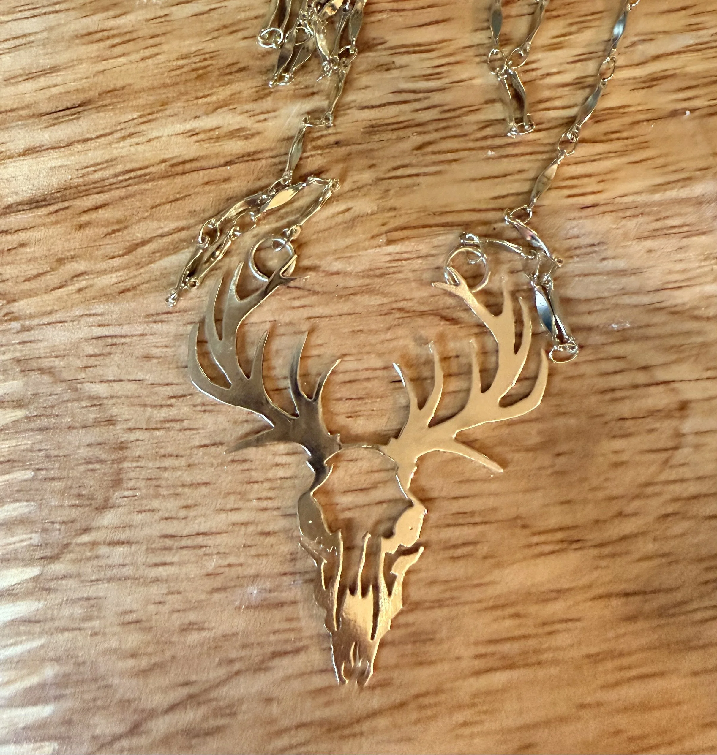 Hand-sawed brass elk's skull.