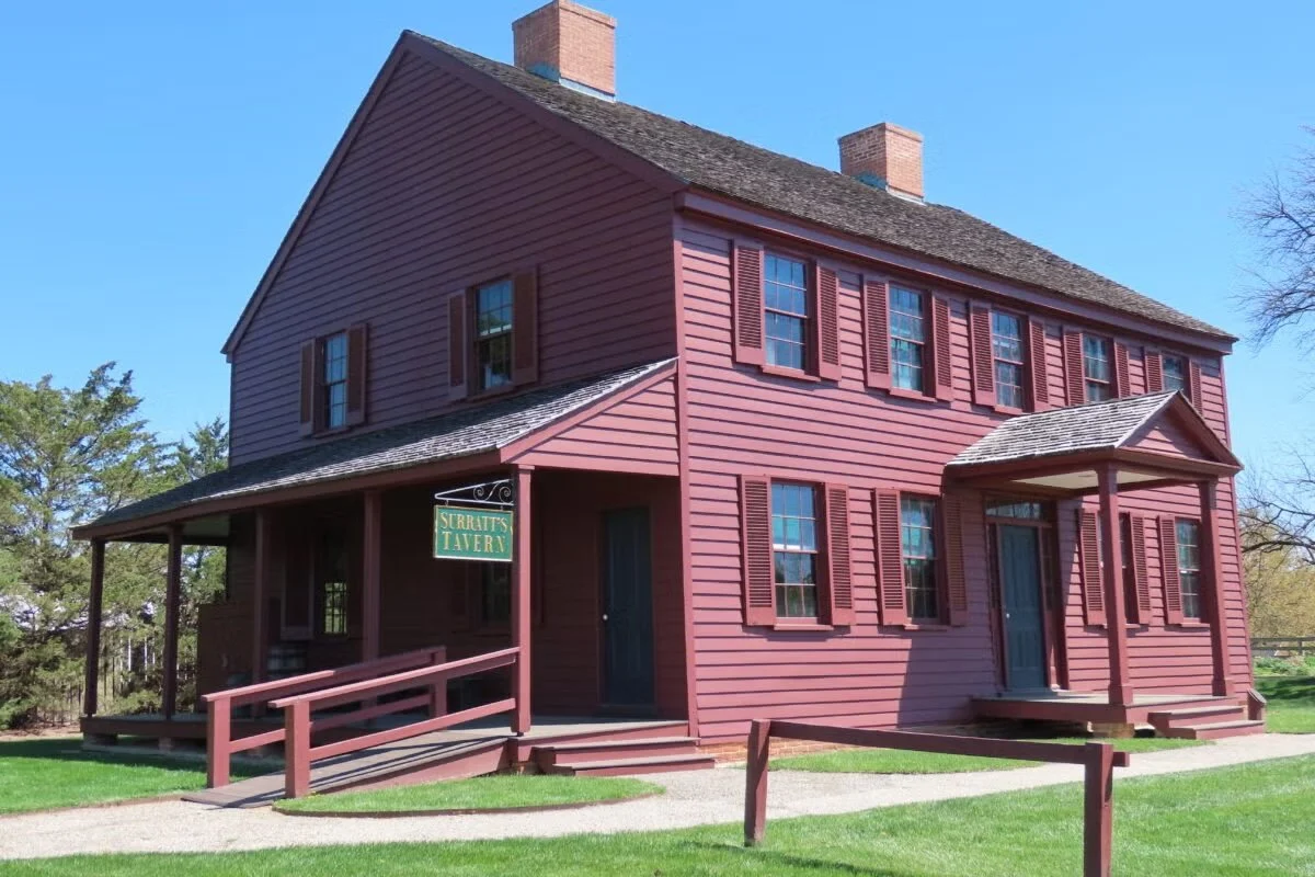 Red house of the historical Surratt Tavern, now the Surratt Museum.