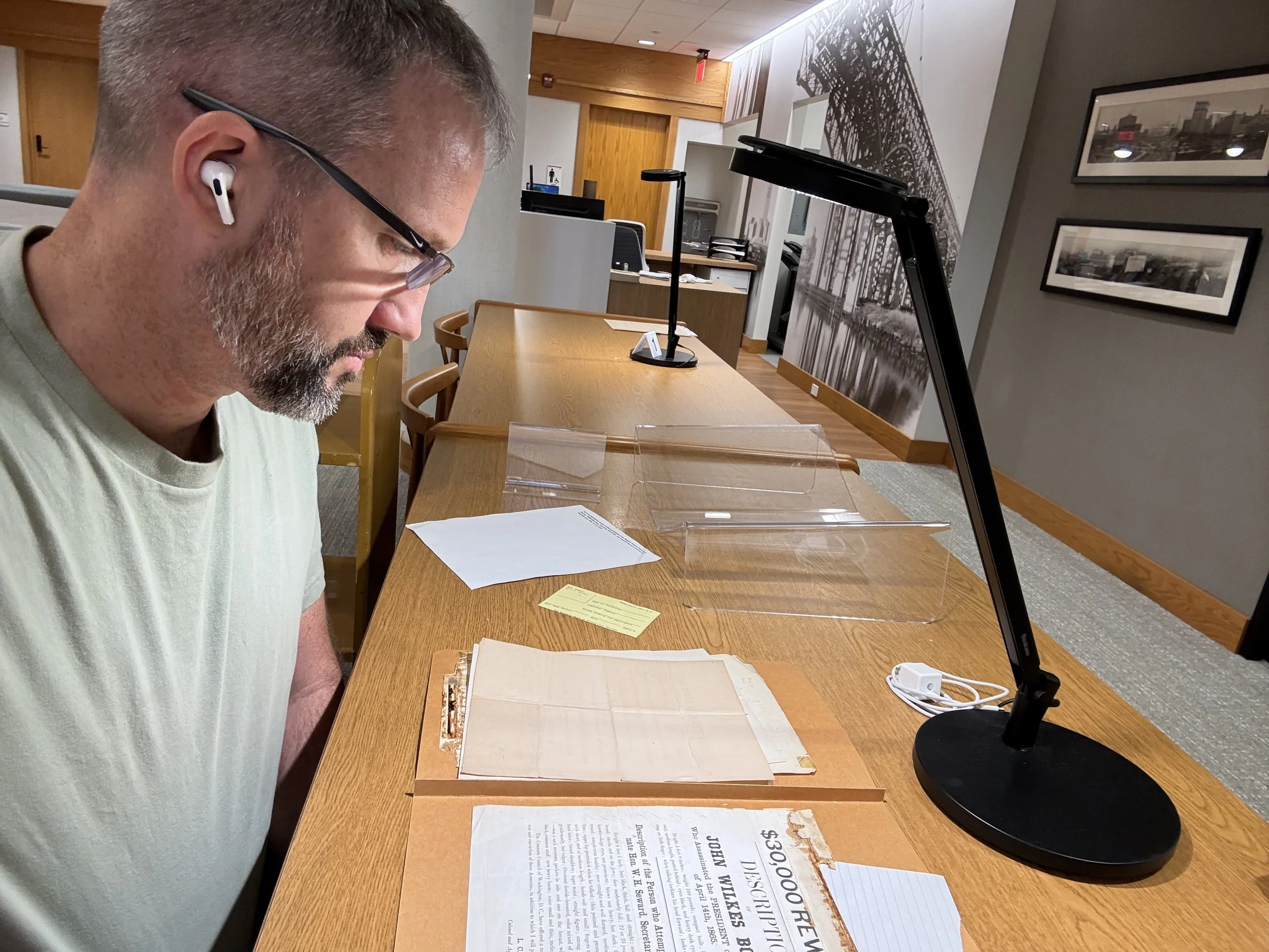 Author Joe Barry reviewing document in research library