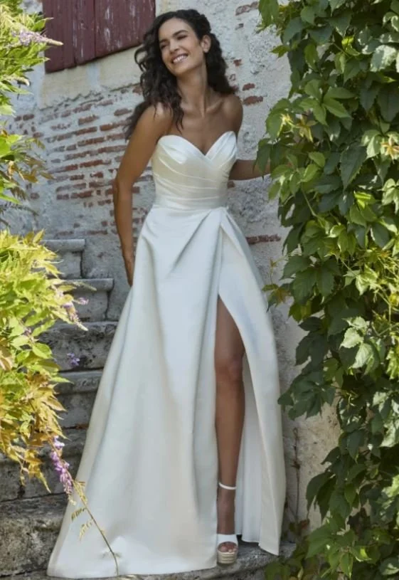 Smiling bride wearing a strapless gown.