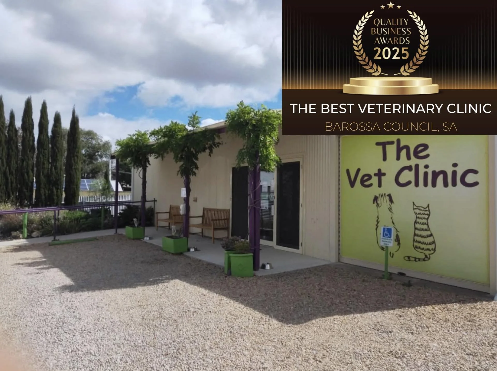 The exterior of a veterinary clinic with a sign reading "The Vet Clinic" in a yellow-green background, decorated with illustrations of a cat and a dog. There are benches, potted plants, and a gravel walkway outside. A large gold and black banner announces "Quality Business Awards 2025" and states "The Best Veterinary Clinic, Barossa Council, SA."