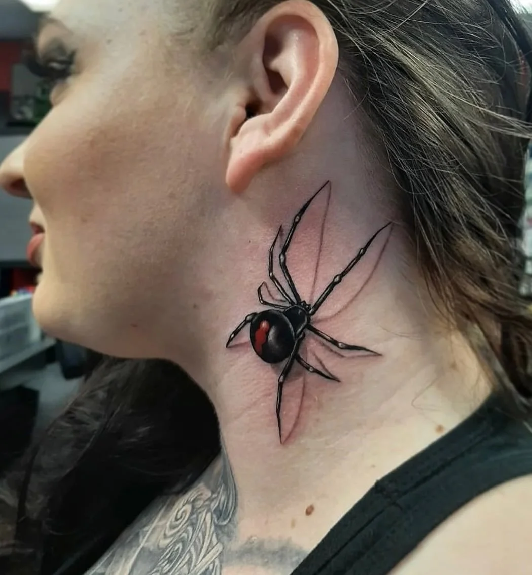 Neck piece done by @korynnwesttattoo 🕷️✨ what an amazing realism black widow neck piece with such clean lines, bold contrast, and that little pop of red to make it come alive. What do you think: spooky or stunning? 👀 #blackwidow #spidertattoo #arti