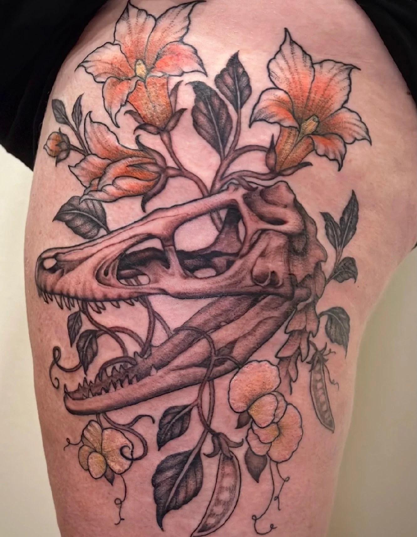 Prehistoric bones, modern bloom 🦴🌿 by @selinatat2 
A nod to strength softened by florals where something long extinct is brought back to life in ink. #dinosaur #tattoo #junipertattoo #florals #beauty #artist