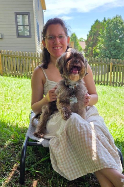 Picture of Marissa sitting down with her dog.