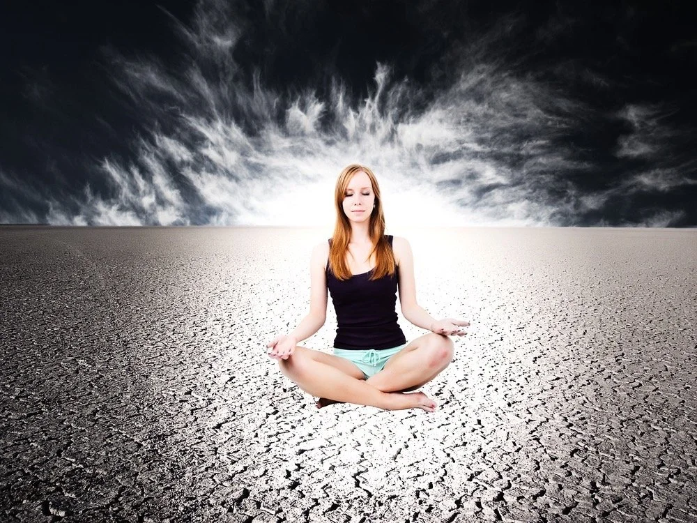girl siting in dry space with grey clouds